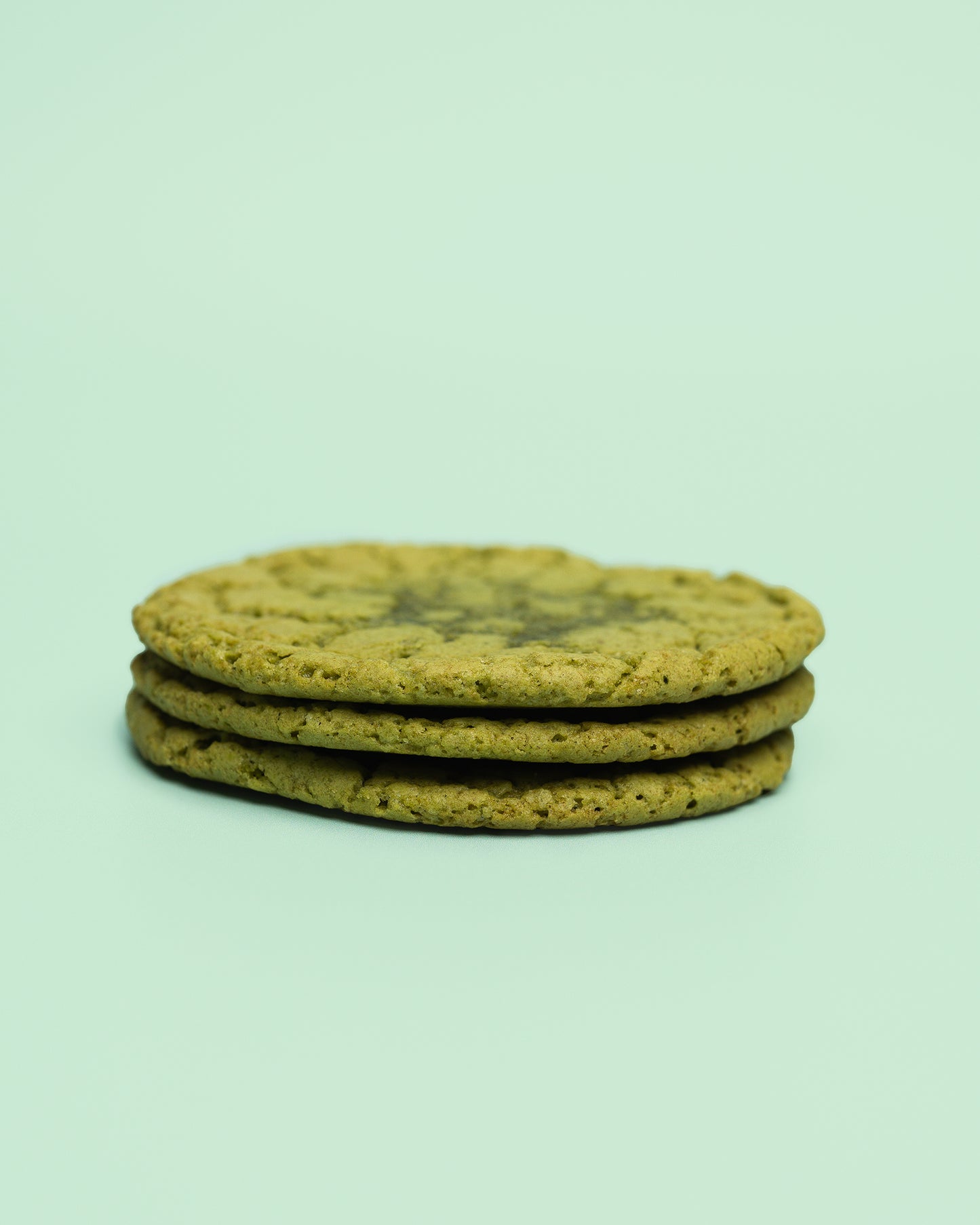 A rich, green-hued Matcha Bliss cookie with a perfectly soft texture, infused with premium matcha and blended white chocolate for a smooth, creamy finish. A delicate balance of earthy and sweet flavors, captured in a beautifully baked treat