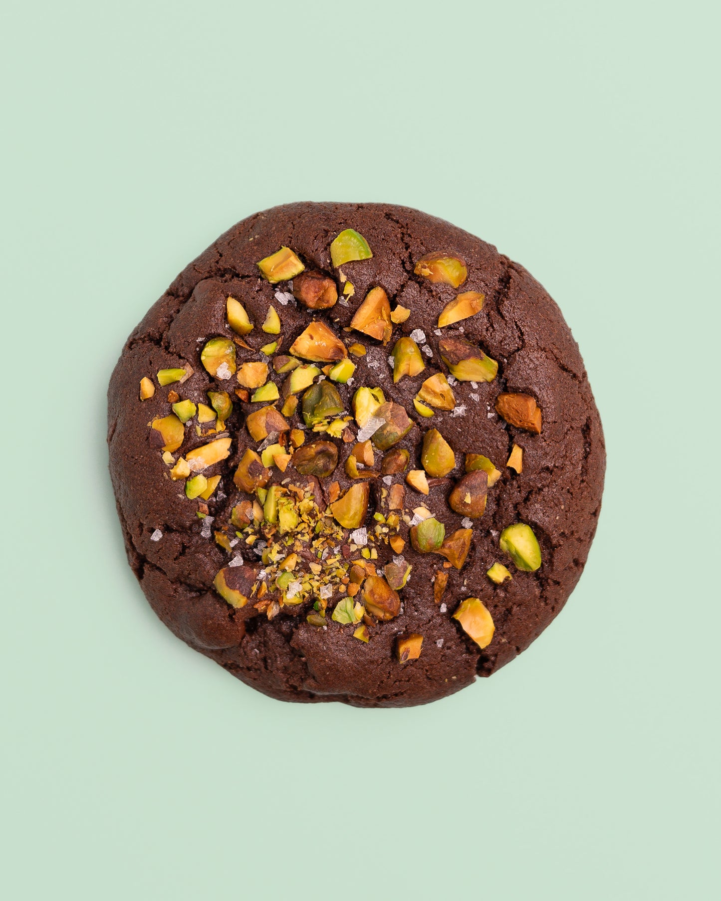 Dubai Chocolate Cookie with a rich, chocolatey exterior, crisp edges, and a soft, fudgy center, filled with crispy Kataifi, creamy Pistachio Butter, and smooth Tahini.