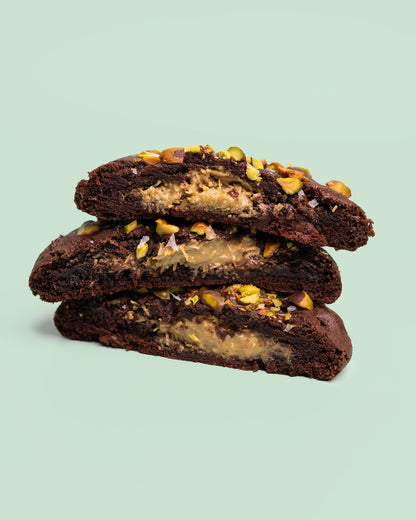 Dubai Chocolate Cookie with a rich, chocolatey exterior, crisp edges, and a soft, fudgy center, filled with crispy Kataifi, creamy Pistachio Butter, and smooth Tahini.