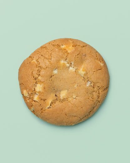 Close-up image of a Stuffed Biscoff Cookie with a golden-brown exterior, cracked top, and creamy Biscoff spread oozing from the center.